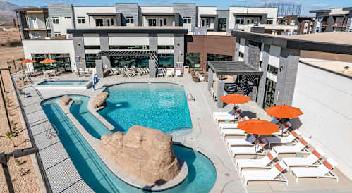 Group of people lying on bed and laughing at The Vue At Desert Color, St. George, UT, 84790