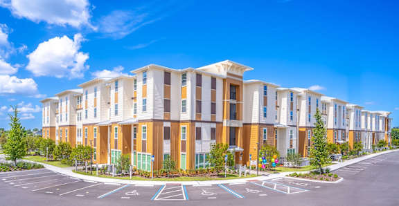 A large building with a parking lot in front of it.