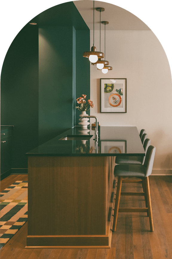 A kitchen with a wooden island and chairs.