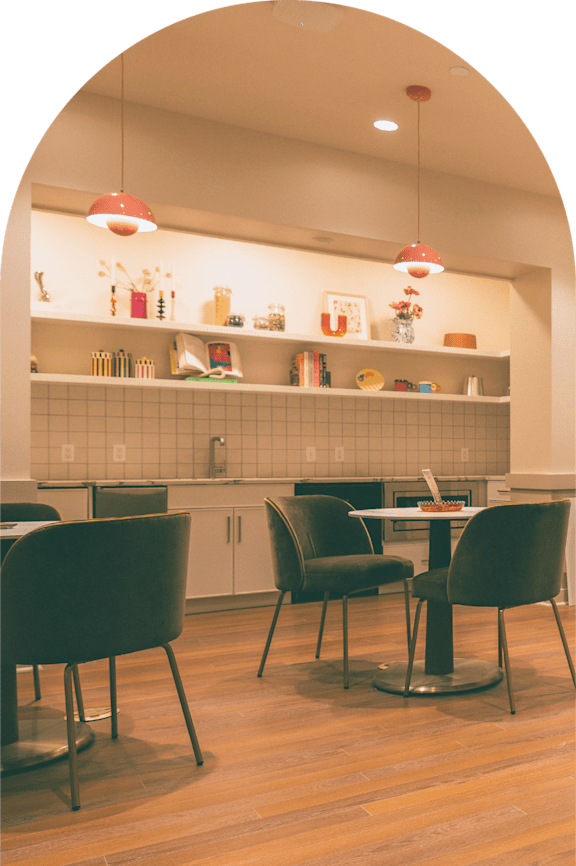 A kitchen with a table and chairs.