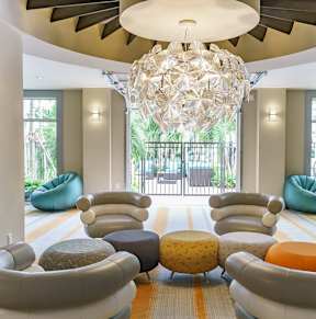 a living room with couches and chairs and a chandelier