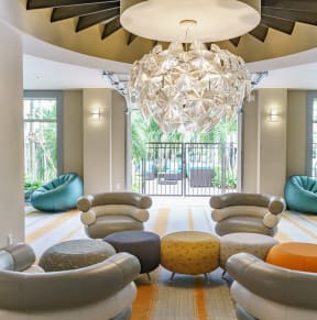 a living room with couches and chairs and a chandelier