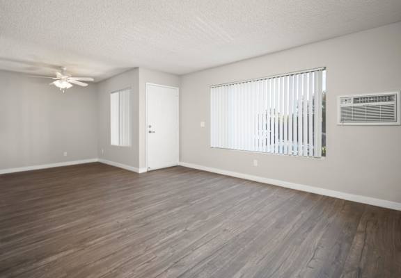 A room with wooden flooring and a ceiling fan.