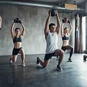 a group of people doing exercises in a gym