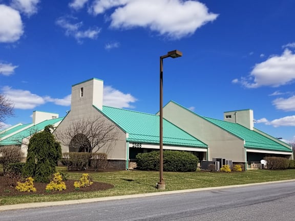 A church with a green roof and a white steeple.