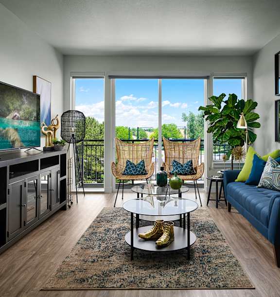 A living room with a blue couch and a coffee table.