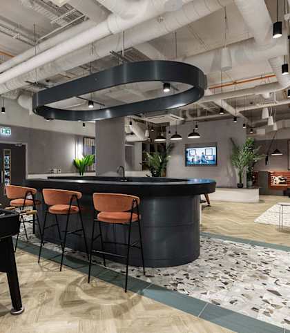 a game room with a foosball table and a bar