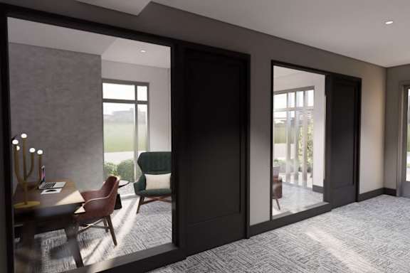 A modern room with a table and chairs and a view of the outside.