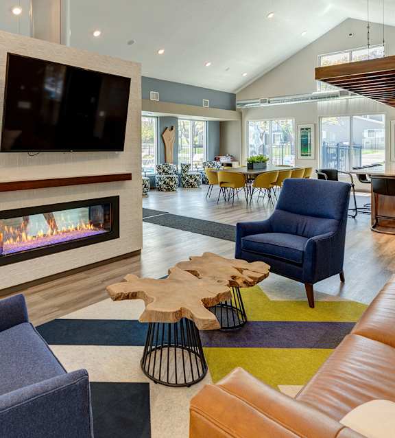 A modern living room with a fireplace and a television.