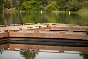 A wooden dock extends into a calm lake.