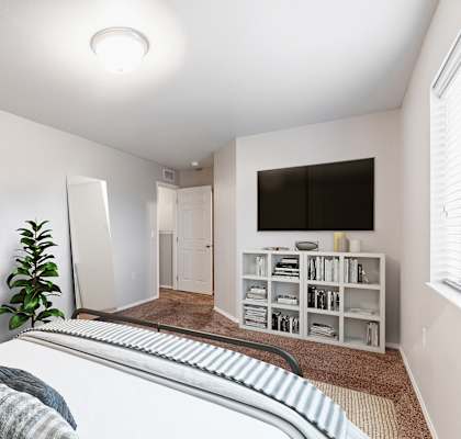 A bedroom with a bed, a plant, and a bookshelf.