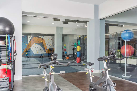 Westwood Green Apartments Wellness room looking back towards the fitness center and rock climbing wall
