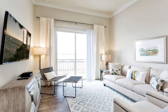 Westwood Green Apartments Living Room with faux wood floors and sliding doors to balcony