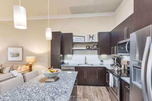 Westwood Green Apartments Kitchen with large island, stainless appliances, and quartz countertops