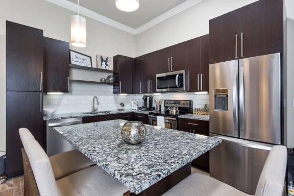 Westwood Green Apartments Kitchen with large island, stainless appliances, and quartz countertops