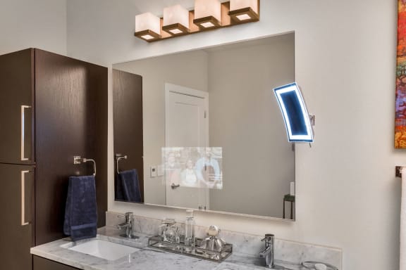 Westwood Green Apartments Bathroom Vanity with tv built into mirror