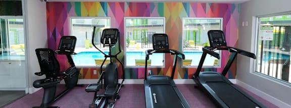 A gym with treadmills and exercise bikes.