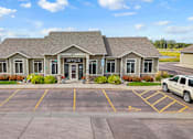 Thumbnail 1 of 9 - A building with the word "OFFICE" on the front door.