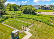 Thumbnail 4 of 8 - A green field with a fence and a small building in the middle.