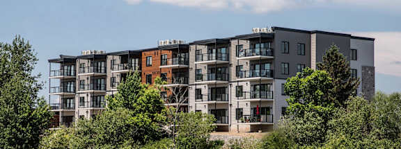 an apartment building overlooking a body of water