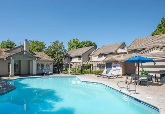 A swimming pool and clubhouse at Zinfandel Village Apartments, California, 95670