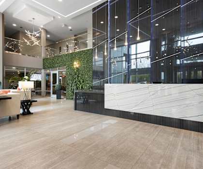 a lobby with a reception desk and a large window
