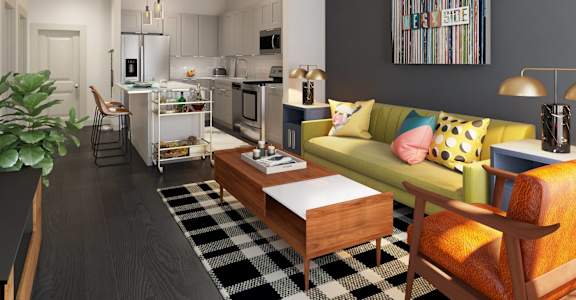 Furnished open-concept living room and kitchen at The Lowery apartments in West Midtown Atlanta, GA.