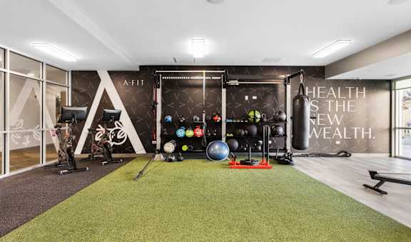 a home gym with a wall mural of a health and the new wealth