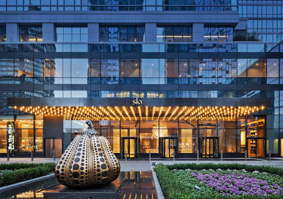 a large building with a sculpture in front of it
