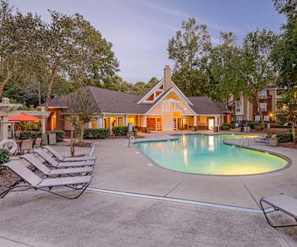 A pool surrounded by lounge chairs and trees at Waverly Place, North Charleston, SC, 29418
