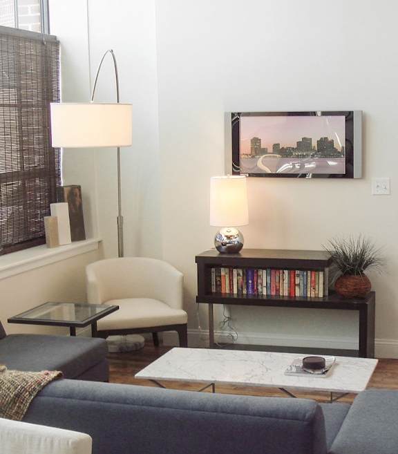 Living room with wood floors and television at Star Mill Lofts Apartments, Middleboro, 02370