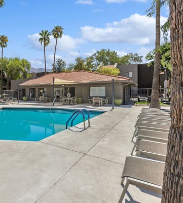 Community Swimming Pool with Pool Furniture at Saddle Ridge Apartments in Tucson, AZ-HERO.