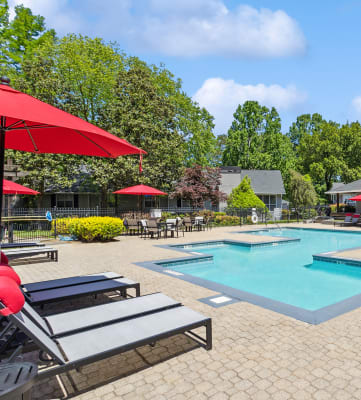 Community Swimming Pool with Pool Furniture at Dunwoody Village Apartments in Atlanta, GA-HERO.