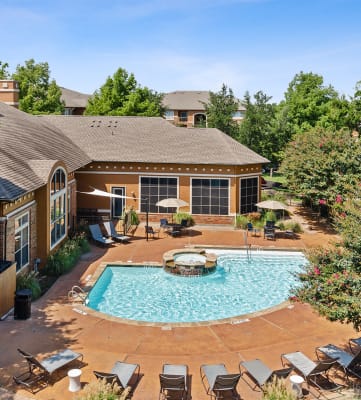 Community pool and sundeck at Belmont at Duck Creek apartments in Garland, TX.