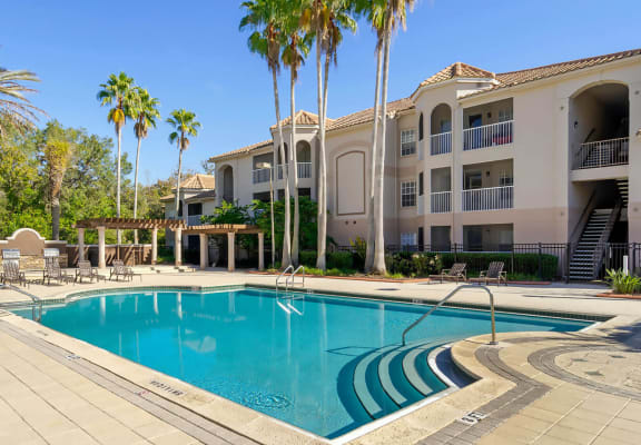 Pool & sundeck at The Vinings At Hunter's Green Apartments in Tampa, FL