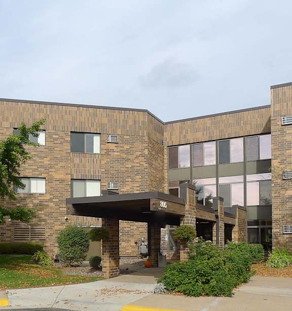 A building with a tree in front of it.