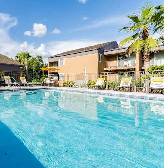 A large swimming pool with a blue tinted water.