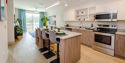 A modern kitchen with a dining table and chairs.
