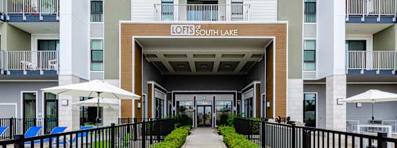 A view of a building entrance with the name "LOFTS & SOUTH LAKE" on the wall.