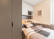 Thumbnail 2 of 16 - a small bedroom with a bed and a closet