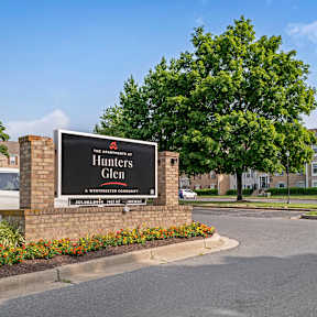 A modern building with a glass facade and a brick exterior.