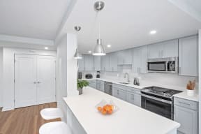 a white kitchen with white cabinets and a white counter top