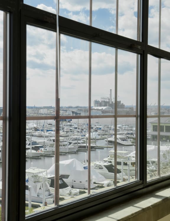 a bedroom with a bed and a couch and a balcony at Tindeco Wharf, Baltimore Maryland