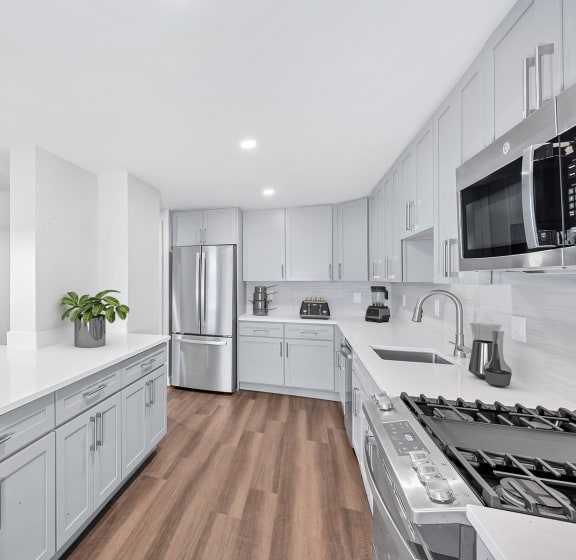 a rendering of a living room and kitchen in a 555 waverly unit