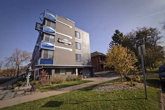 A modern building with a curved design and balconies.