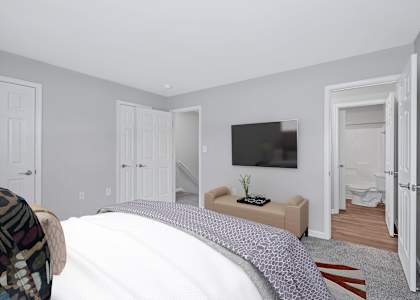 a bedroom with a tv on the wall