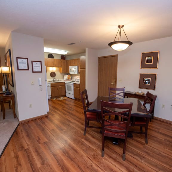 a dining room and living room with a table and chairs