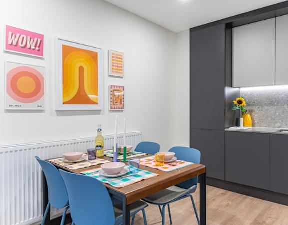 a dining room with a table and chairs and a kitchen