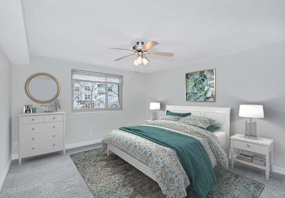 a bedroom with a bed and a ceiling fan