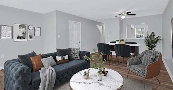 a living room with gray walls and a white marble coffee table